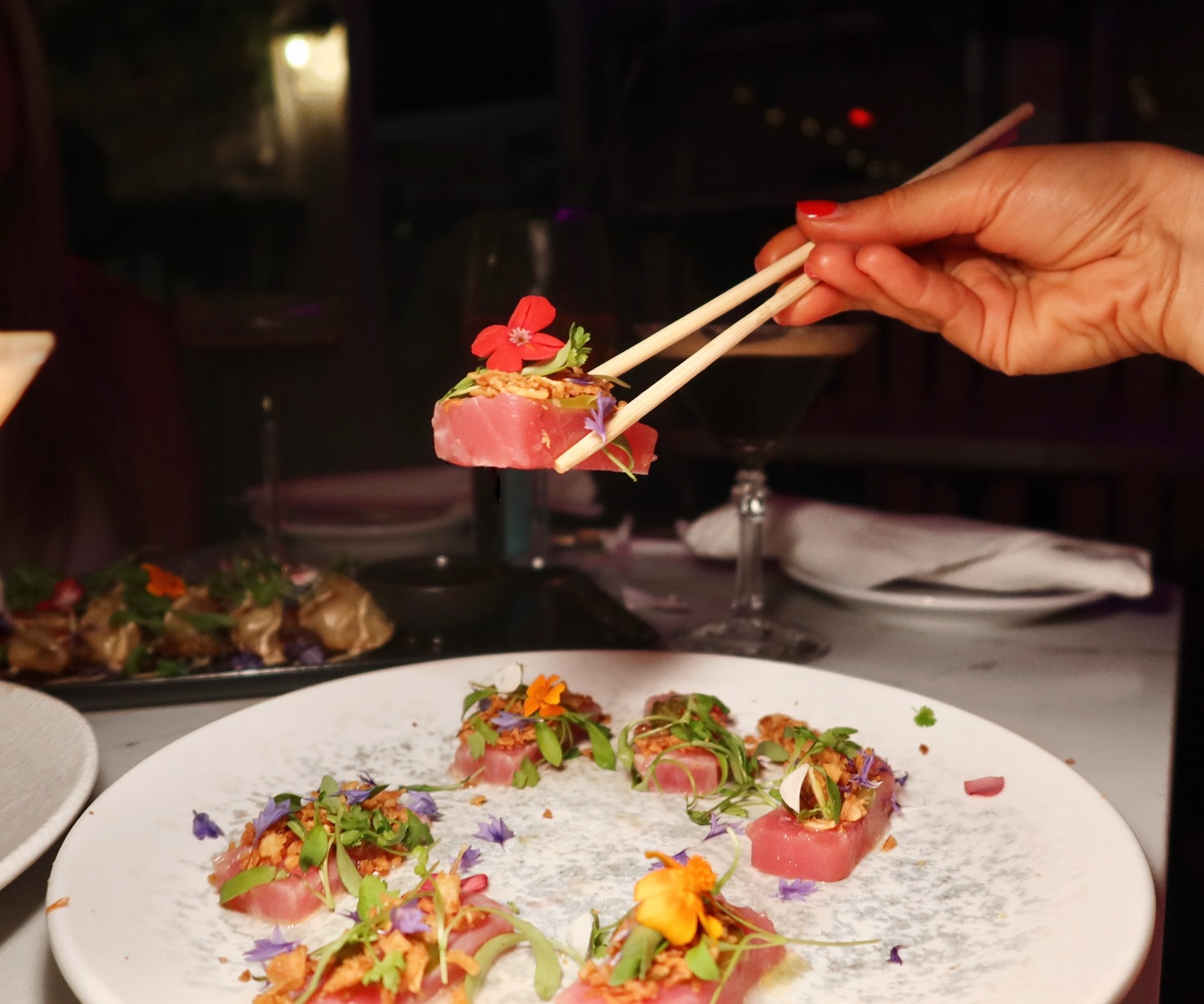 Gourmet tacos with pickled onions and edible flowers at Somewhere Dine Bar